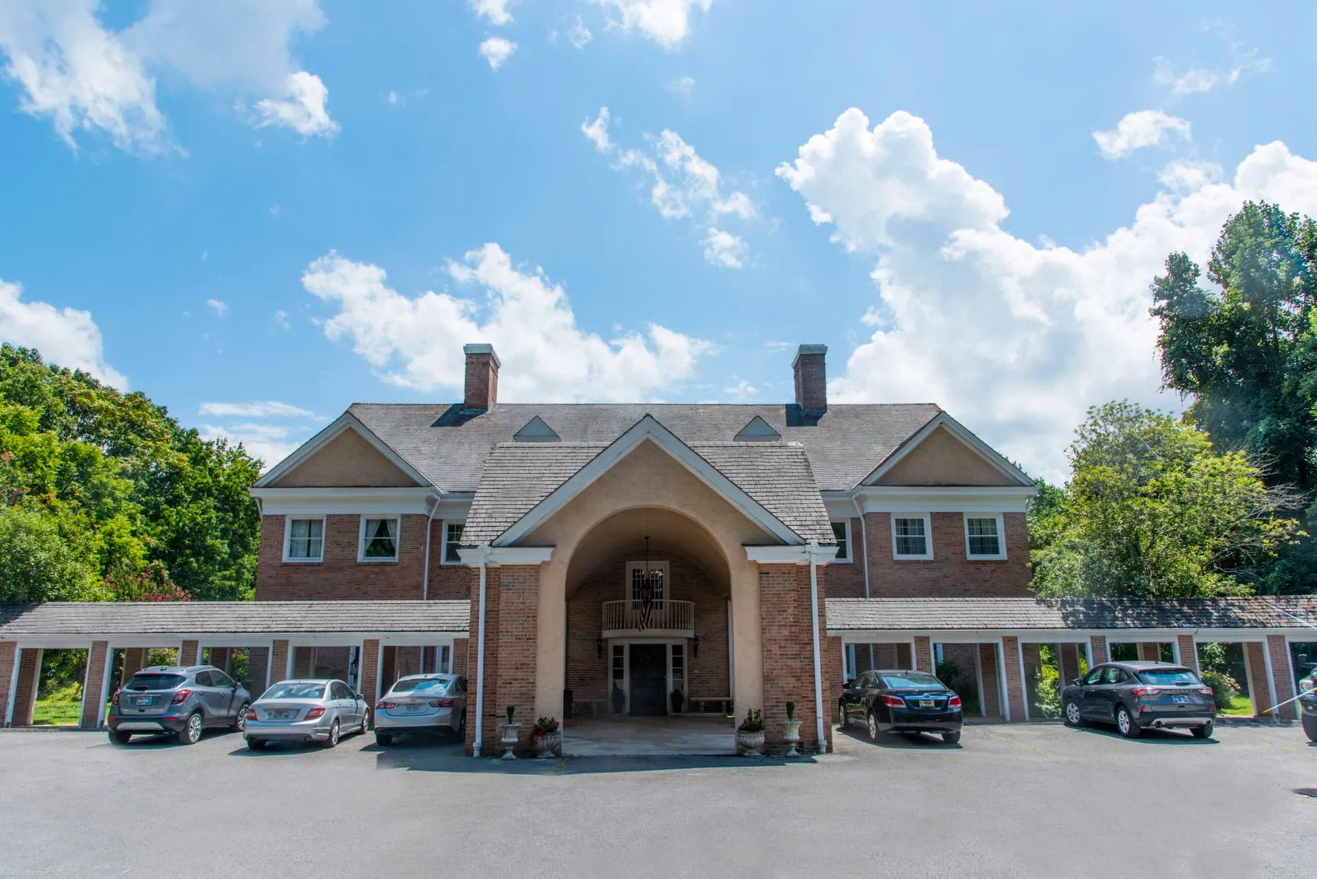 The covered entrance and porte-cochere at the front of the facility