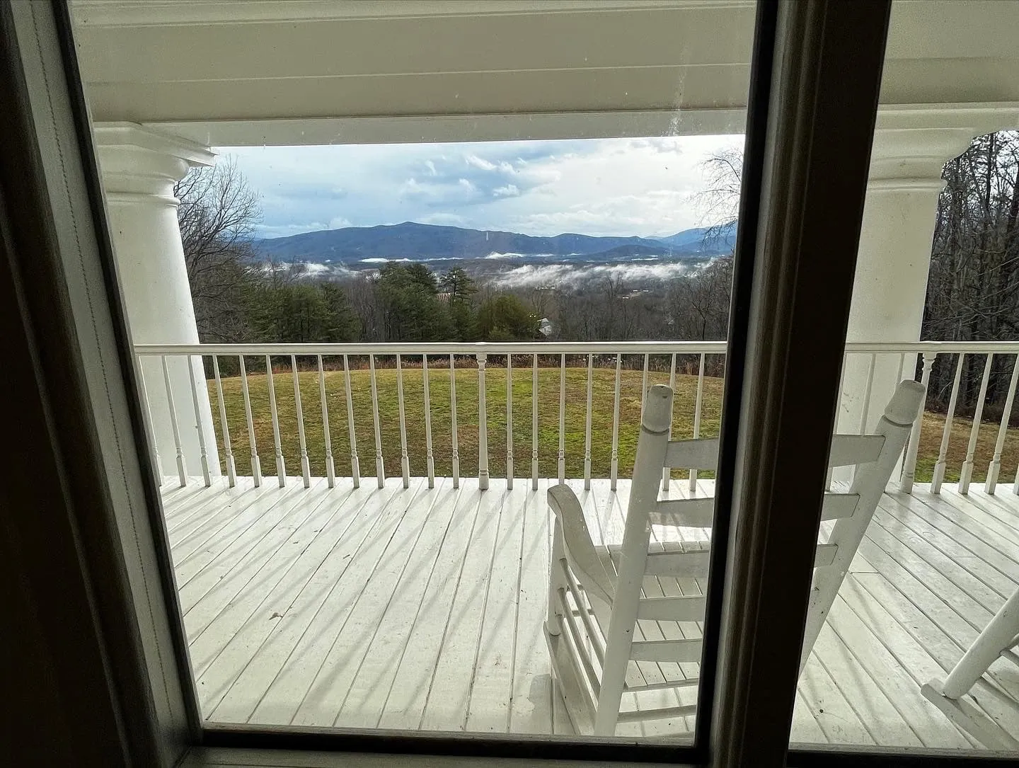 Rocking chairs on the upper porch looking out to the Smoky Mountains